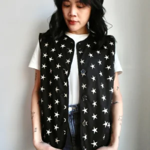 Front view of a black vest with embroidered silver star pattern, made from sustainable materials.