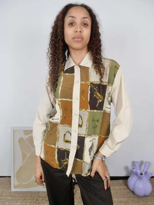 Front view of a vintage beige and multicolour print blouse.