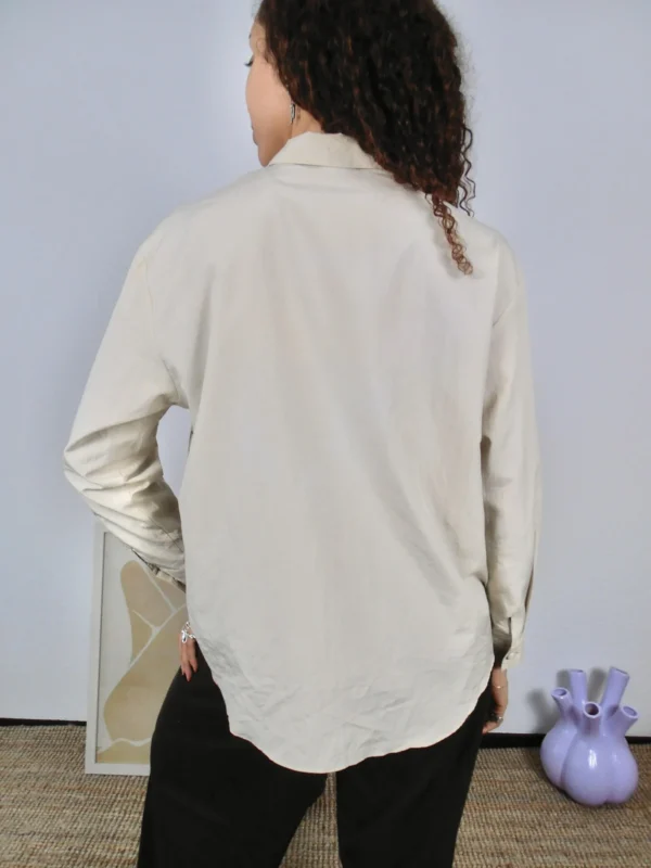 Back view of a vintage beige and multicolour print blouse.