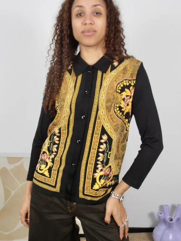 Front view of a vintage black and gold multicolour print button-up blouse.