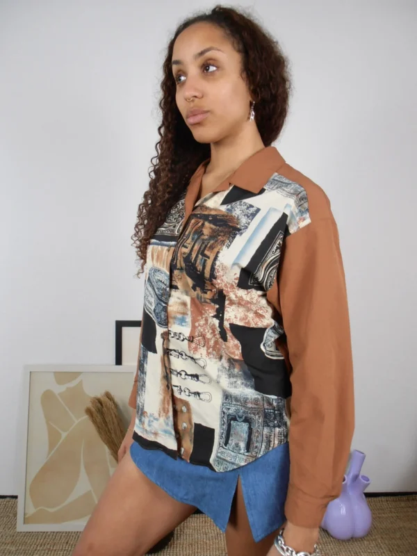 Side view of a vintage tan and multicolour print blouse.