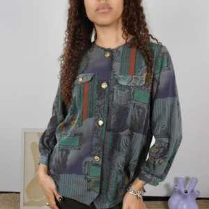 Front view of a vintage multicolour print blouse with gold/silver buttons.