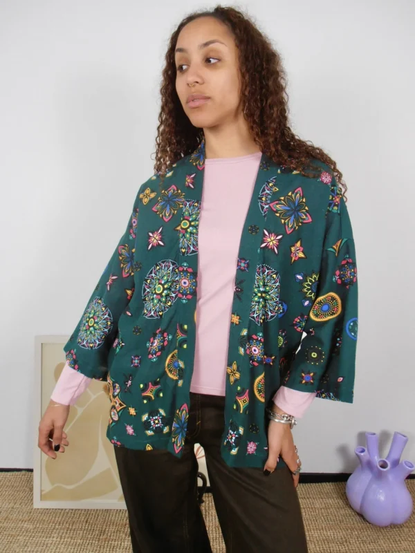 Front view of a sustainably made green kimono with multicolor pattern on cotton-linen deadstock fabric.