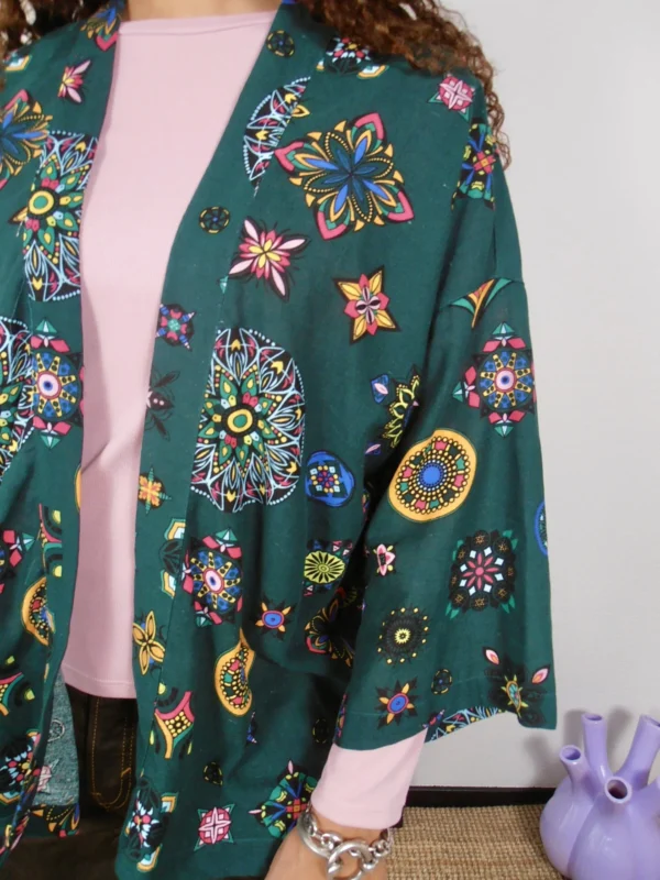 Close-up of an upcycled green kimono with multicolor pattern on cotton-linen deadstock fabric.